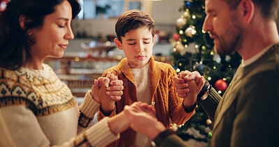 Buy stock photo Family, praying and holding hands in home for Christmas, solidarity and gratitude with spiritual connection. Parents, boy and worship in living room for thanks, faith and vacation as Christian people