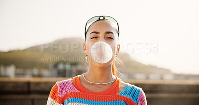 Buy stock photo Woman, bubble gum and portrait in city, summer and trendy style with chewing, candy and outdoor in street. Girl, persona and sweets with fashion, streetwear and attitude on metro bridge in Colombia