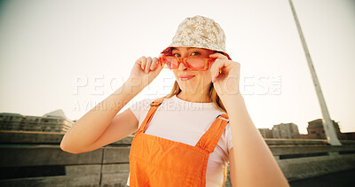 Buy stock photo Bridge, woman and portrait with sunglasses for fashion, streetwear and confidence for cool clothes with pride. Urban, female person and smile with positivity for hipster, trendy hat and gen z in city