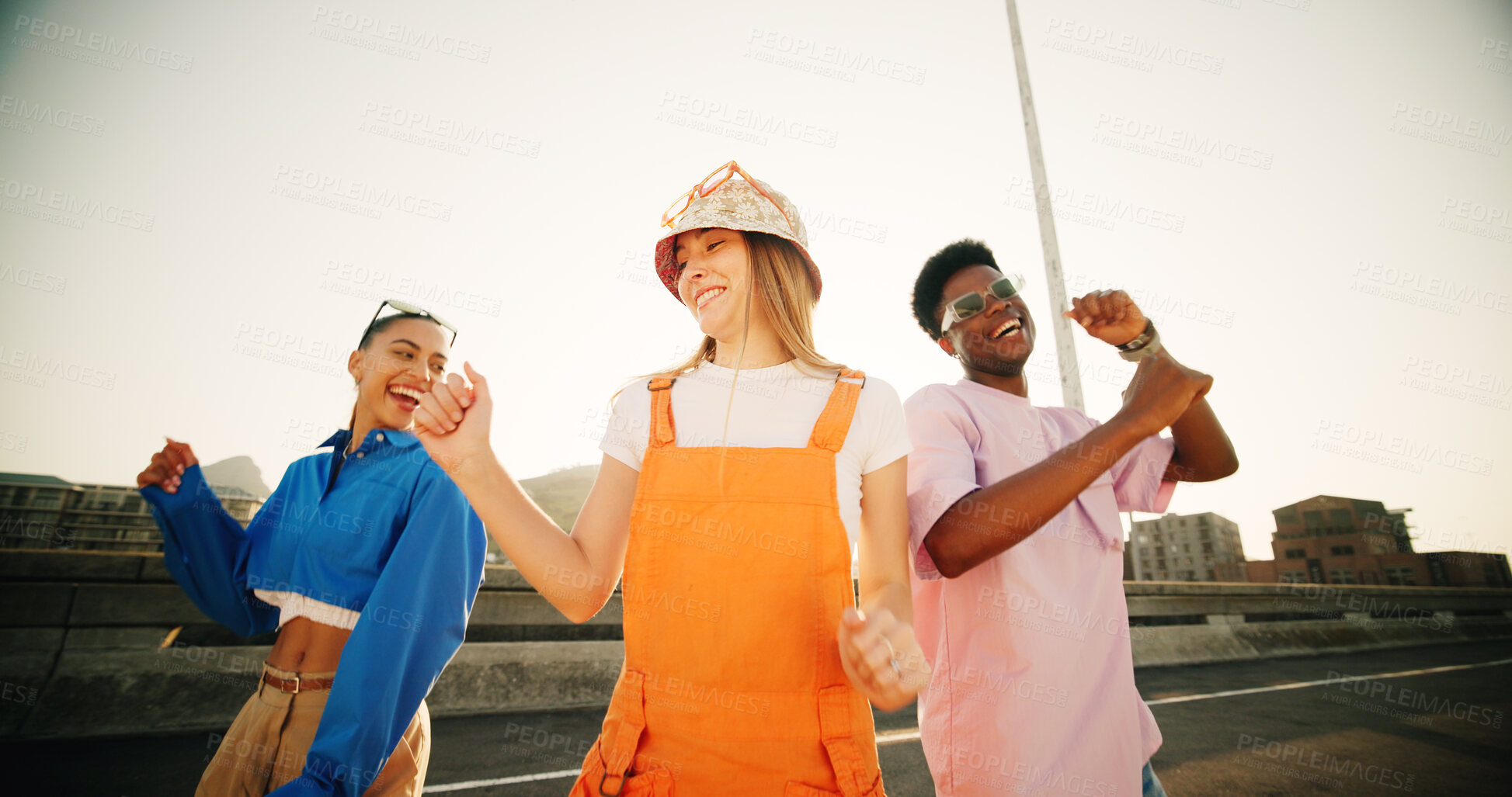 Buy stock photo City, fun and group of happy people with dance, diversity and cool streetwear style at sunset. Excited, smile and gen z friends with urban fashion, positive energy and bonding in street together.