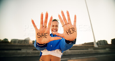 Buy stock photo Hands, pronouns and person with she, her and happy for gender, inclusion and sexuality with opinion in street. Girl, excited and palm with writing, voice and sign with news, announcement and identity