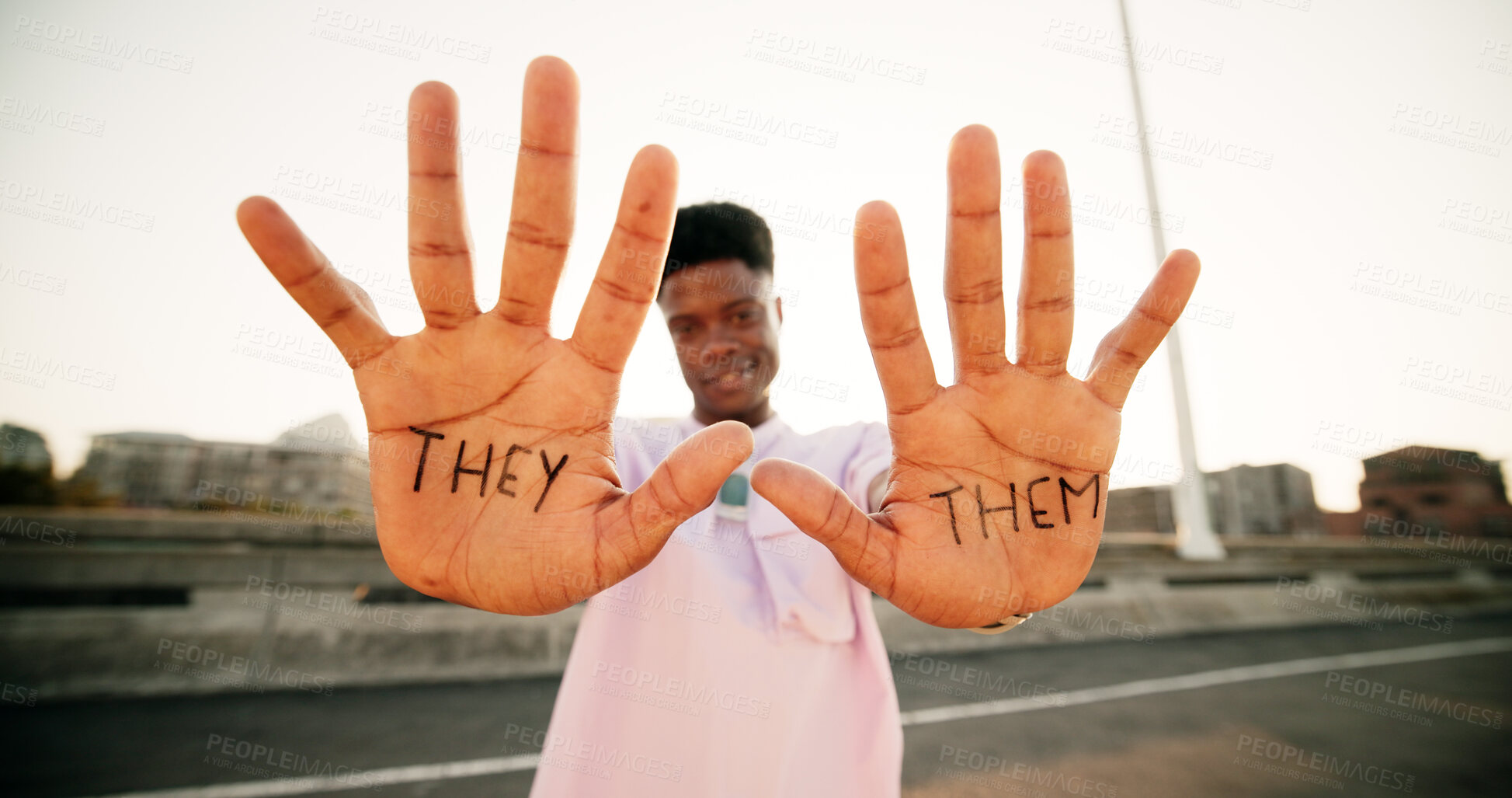 Buy stock photo Hands, they and them with sign, person and gender identity with voice, opinion and portrait on metro bridge. African student, happy and open palm with writing, protest and lgbtq inclusion in Kenya