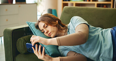 Buy stock photo Bored, woman and relax with phone on couch for communication, social media and reading notification. Tired, girl and mobile for message error, online chat or stress with game fail of mistake at house