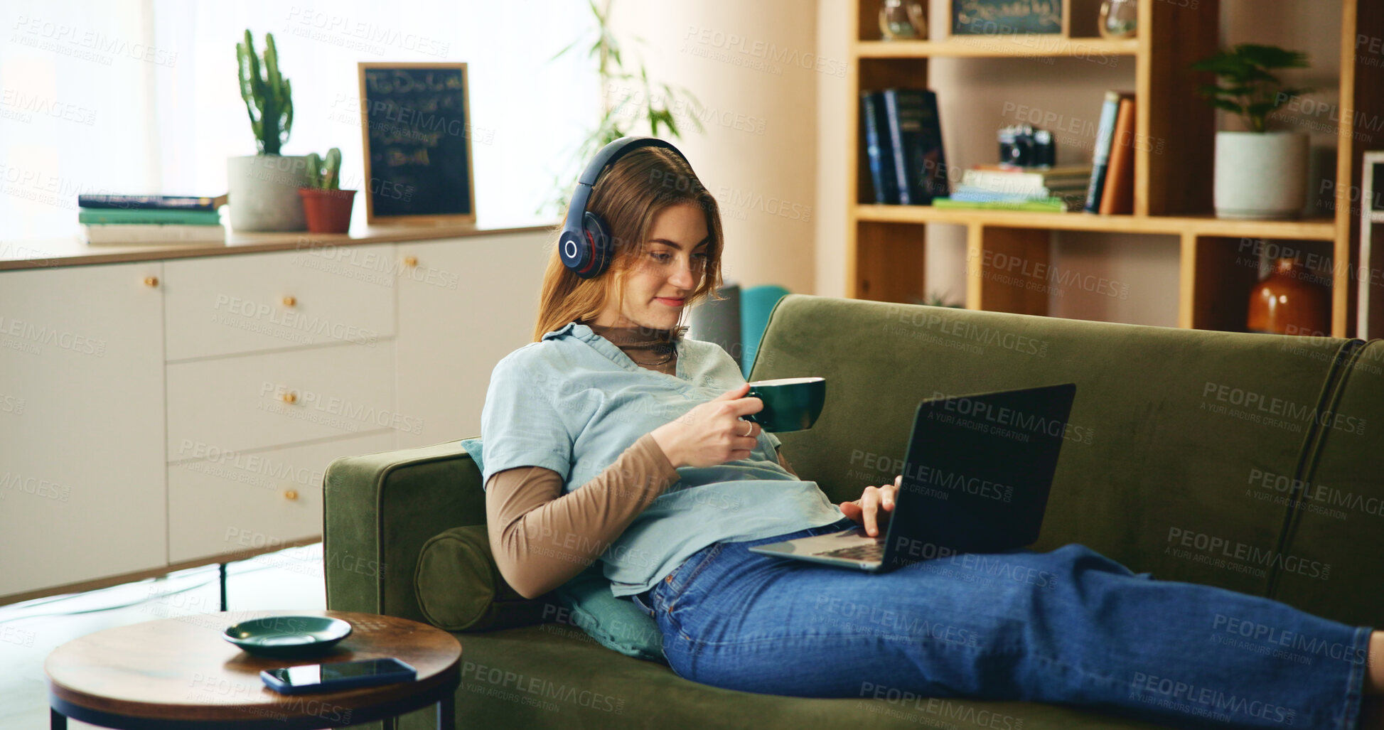 Buy stock photo Laptop, headphones and girl on sofa with coffee, comfort or listening to online webinar in home. Elearning, relax and student on couch with computer, podcast connection or music streaming in lounge