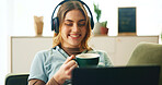 Laptop, headphones and happy woman on sofa with coffee, comfort or listening to online webinar in home. Elearning, relax and girl on couch with computer, video connection or music streaming in lounge