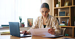 Woman, reading and document with laptop at house for loan approval, bank application and budget planning. Girl, online taxes and review paperwork for mortgage, financial invoice and investment letter