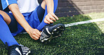 Hands, person and ready with sneakers on soccer field of game warm up, preparation and sports challenge. Athlete, tie and shoes for football competition, fitness performance and tournament training