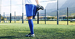 Legs, person and stretching for fitness on soccer field for sports game, exercise and warm up challenge. Athlete, player and prepare for football competition, workout performance and start tournament