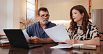 Home, laptop and old couple with paperwork, budget and finance planning in living room. Apartment, senior man and woman with pc, documents or retirement fund with mortgage, savings or property assets