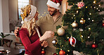 Christmas, happy and tree with couple and decoration for bauble, gift giving and festive season. Xmas, holiday and celebration with man and woman in living room at home for tradition, noel and winter