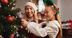 Christmas, smile and tree with mother and daughter for decoration, gift giving and festive season. Xmas, holiday and celebration with woman and child in family home for tradition, noel and winter