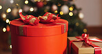 Box, Christmas and present in living room, sparkle and season for giving, festive and decoration for event. House, celebration and creative with ribbon, red color and tradition for holiday and party