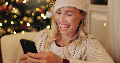 Buy stock photo Christmas, home and woman with cellphone, typing and smile for social media, message or funny. Happy person, Xmas or girl in lounge, smartphone or online chatting with contact, digital app or festive