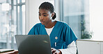 Hospital, doctor and black woman with laptop, typing and thinking with research, online reading and network. African person, medical or professional with computer, nurse and digital app with internet