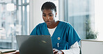 Hospital, nurse and black woman with laptop, typing and thinking with research, online reading and internet. African person, medical or professional with computer, doctor and digital app with email