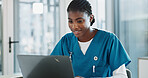 Clinic, doctor and black woman with laptop, typing and thinking with research, online reading and network. African person, medical or happy professional with computer, nurse or connection in hospital