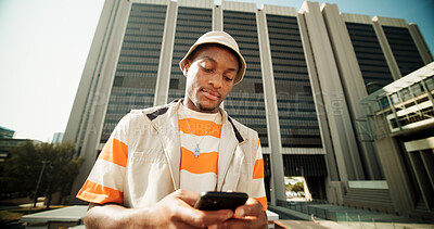 Buy stock photo Fashion, typing and black man with smartphone, outdoor and digital app with connection, buildings and texting. African person, cellphone and guy in street, city and message to contact or social media