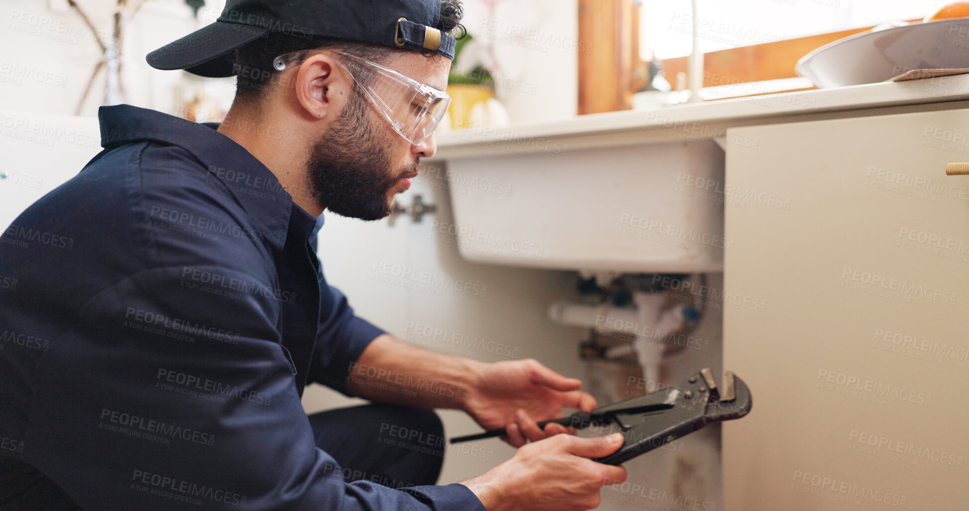 Buy stock photo Plumber, house or handyman with wrench for maintenance, skills or small business. Person, employee or repair with equipment, safety or industry with service, home renovation or labour with contractor