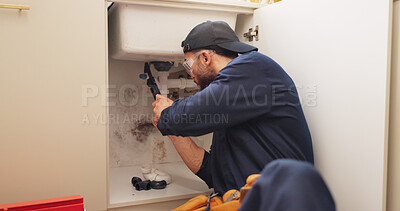 Buy stock photo Plumber, man and tools for pipeline in kitchen with home maintenance service and fixing leak by sink. Plumbing contractor, handyman or working on filter system improvement for small business in house