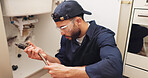 Plumber, man and pipe inspection in kitchen with safety for home maintenance or fixing leak by sink. Plumbing contractor, handyman or working on filter system installation for small business in house