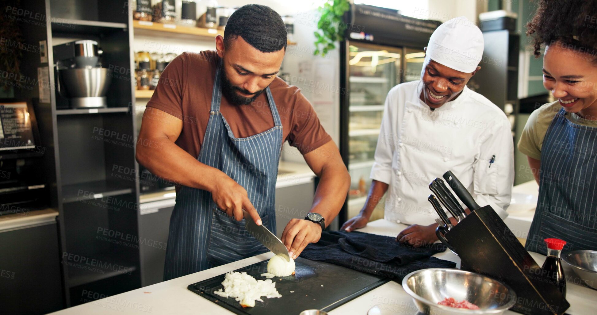 Buy stock photo Cooking, course and chef teaching students in kitchen for knife skills, cutting technique and learning. Culinary class, people and mentor with lesson on food preparation and education in hospitality