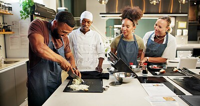 Buy stock photo Cooking, class and chef teaching students in kitchen for knife skills, cutting technique and learning. Culinary course, people and mentor with lesson on food preparation and education in hospitality