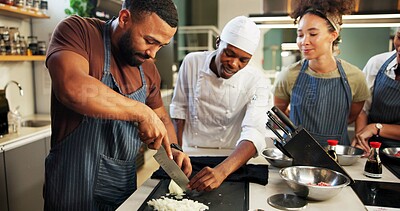 Buy stock photo Cooking, course and chef teaching man in kitchen for knife skills, cutting technique or learning process. Culinary class, people or mentor with lesson on onion preparation or education in hospitality