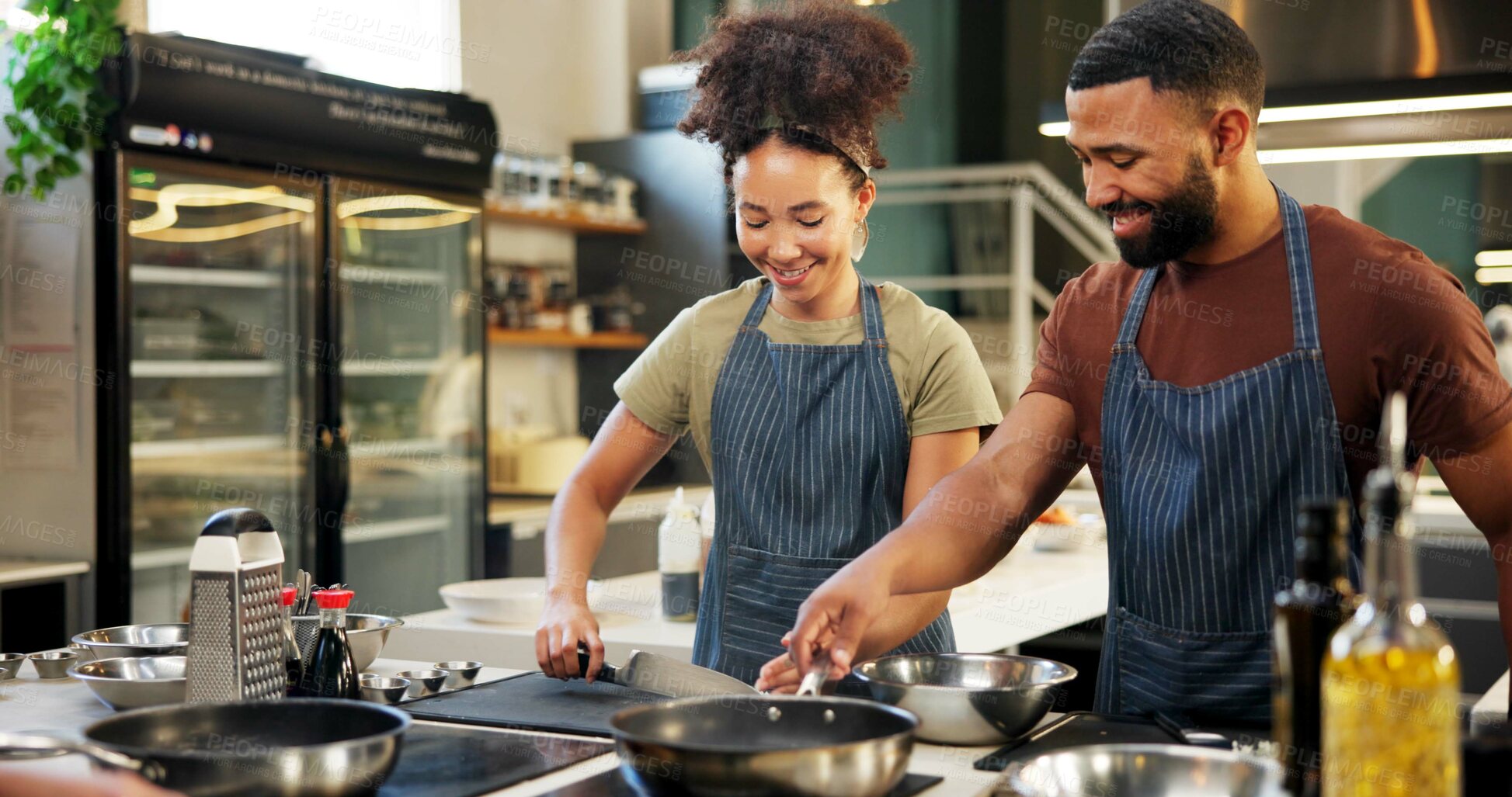 Buy stock photo Happy, chef and helping in kitchen, cooking and listening to instruction, mentor or teaching in hospitality. Professional, apprentice and learning of culinary student, smile or skills for fine dining