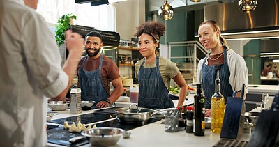 Buy stock photo Learning, chef and group in kitchen, cooking and listening to instruction, mentor and teaching in hospitality. Professional, people and culinary students with smile and skills for fine dining