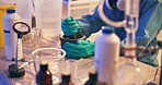 Hands, gloves and chemical in lab, drugs or production for illegal market with mortar, container or powder. Person, crime and ppe for hazard, process or underground network for narcotics distribution