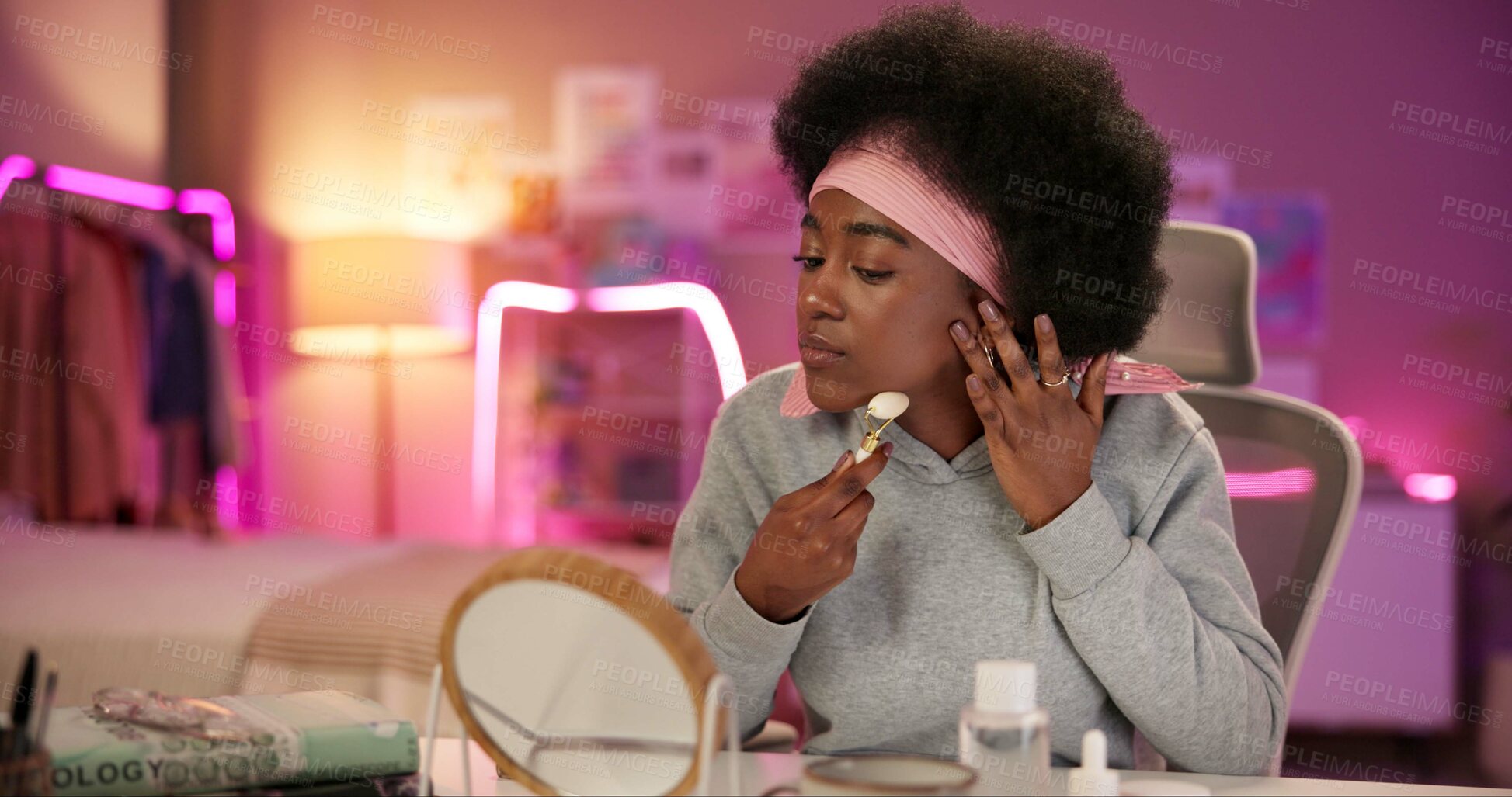 Buy stock photo Face roller, night and skincare with black woman in bedroom for beauty routine, lymphatic drainage and self care. Cosmetics, collagen and product with person at home for facial, detox and dermatology