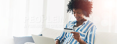 Buy stock photo Cropped shot of a young woman using a credit card to make an online payment at home