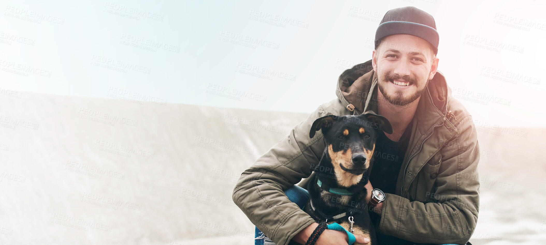 Buy stock photo Portrait of a young man and his dog spending time together outdoors