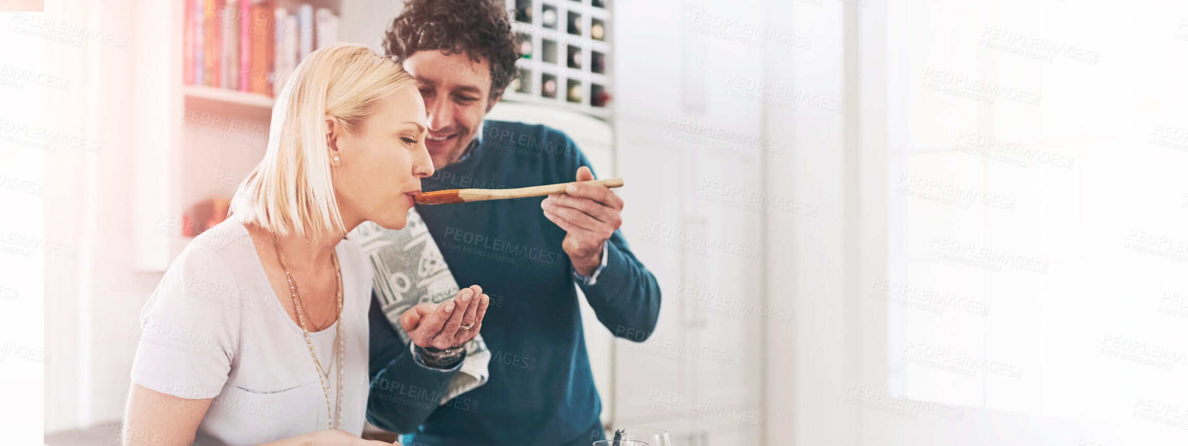 Buy stock photo Shot of a happy couple cooking dinner together in their kitchen