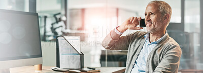 Buy stock photo Shot of a mature businessman talking on the phone while sitting at his desk in an office