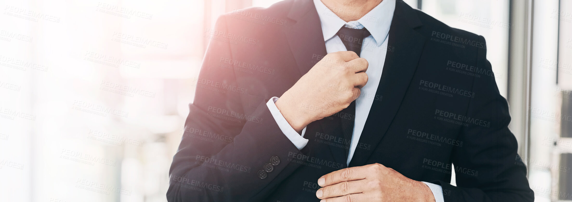 Buy stock photo Closeup shot of a mature businessman straightening his tie while standing in an office