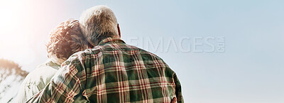 Buy stock photo Rearview shot of a senior couple embracing outside on the balcony