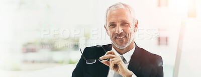 Buy stock photo Portrait of a smiling mature businessman sitting at his desk in an office