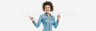 Buy stock photo Studio shot of an attractive young woman pointing in two different directions