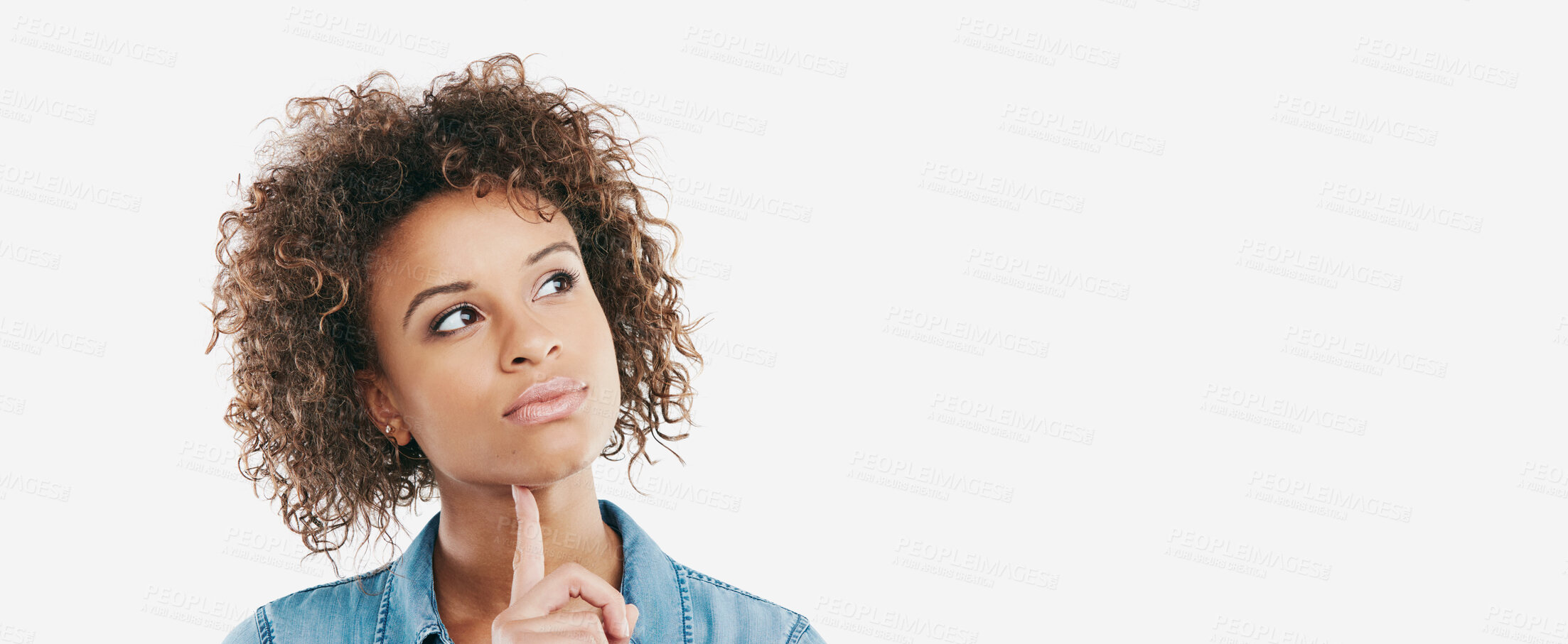 Buy stock photo Studio shot of an attractive young woman looking thoughtful against a white background