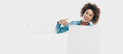 Buy stock photo Studio shot of an attractive young woman holding a placard