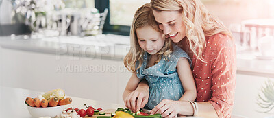 Buy stock photo Cropped shot of a mother and daughter preparing a meal together at home