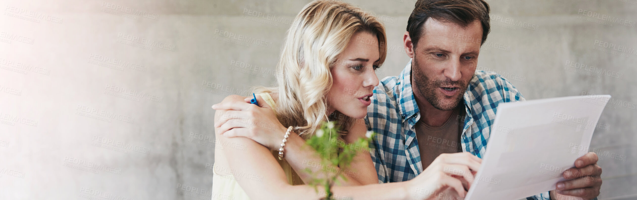 Buy stock photo Shot of a couple going through their paperwork together at home