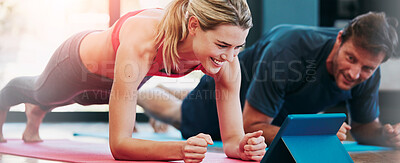 Buy stock photo Cropped shot of a sporty couple working out together at home