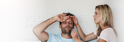 Buy stock photo Shot of a woman taking her husband's temperature