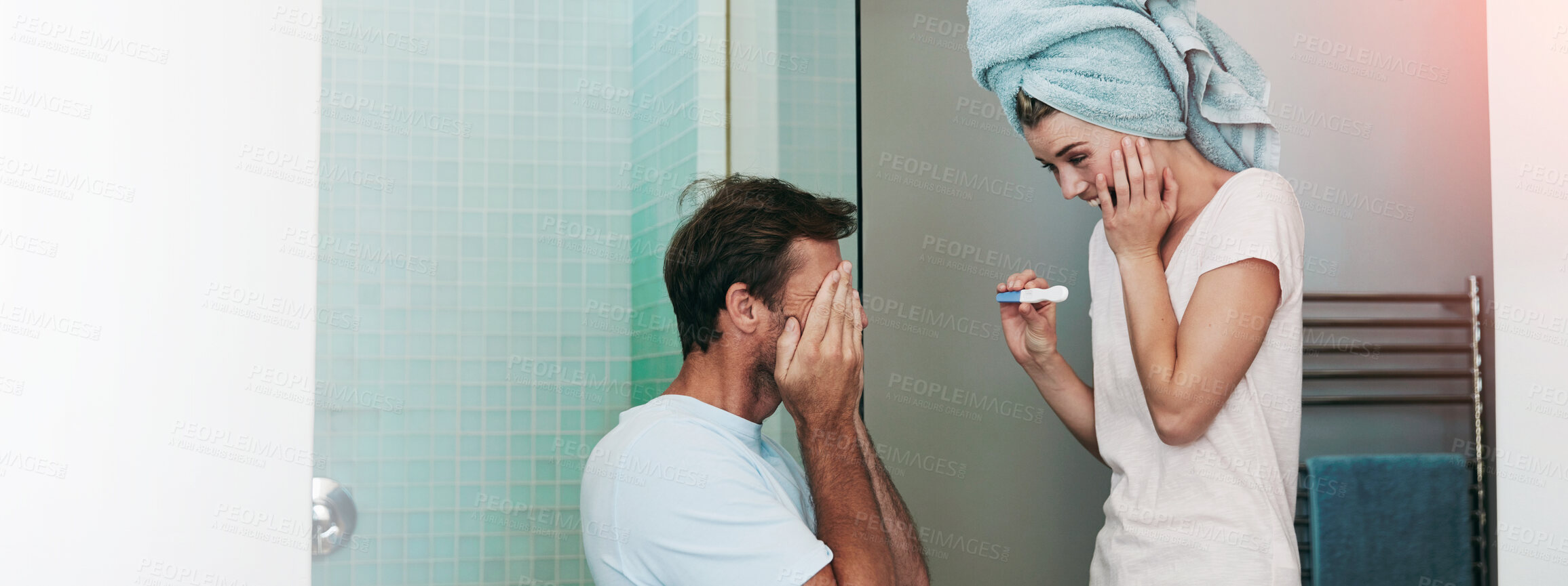 Buy stock photo Shot of a young couple looking happy after taking a pregnancy test in the bathroom