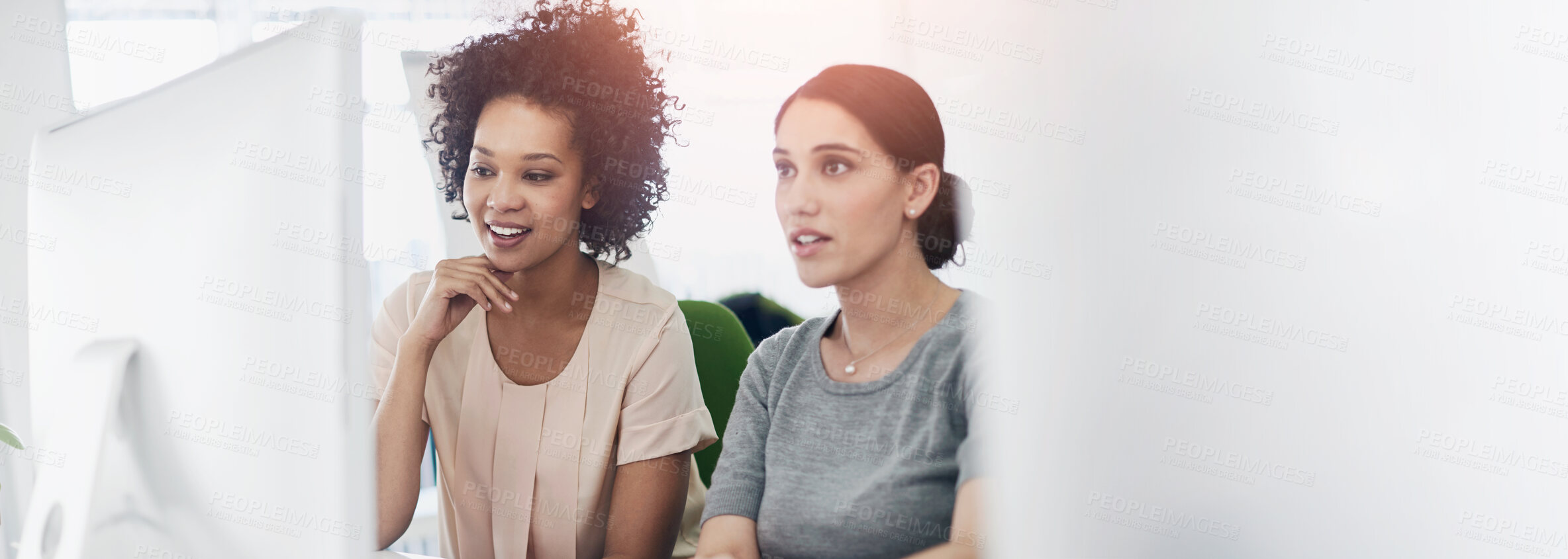 Buy stock photo Shot of two creative businesspeople working together on a computer in the office