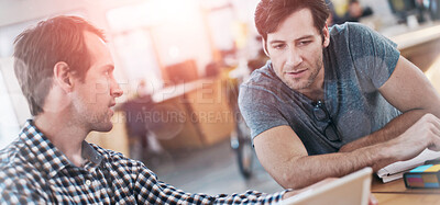 Buy stock photo Shot of business colleagues discussing matters with the help of wireless technology in their office