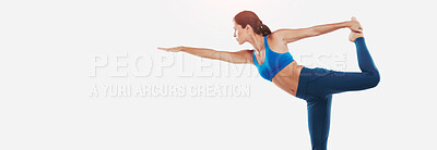 Buy stock photo Shot of a sporty young woman practicing yoga against a white background