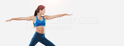 Buy stock photo Shot of a sporty young woman practicing yoga against a white background